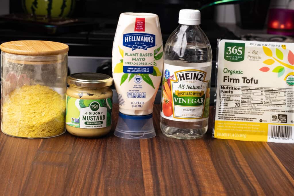 Nutritional yeast, dijon mustard, vegan mayo, white vinegar and firm tofu.