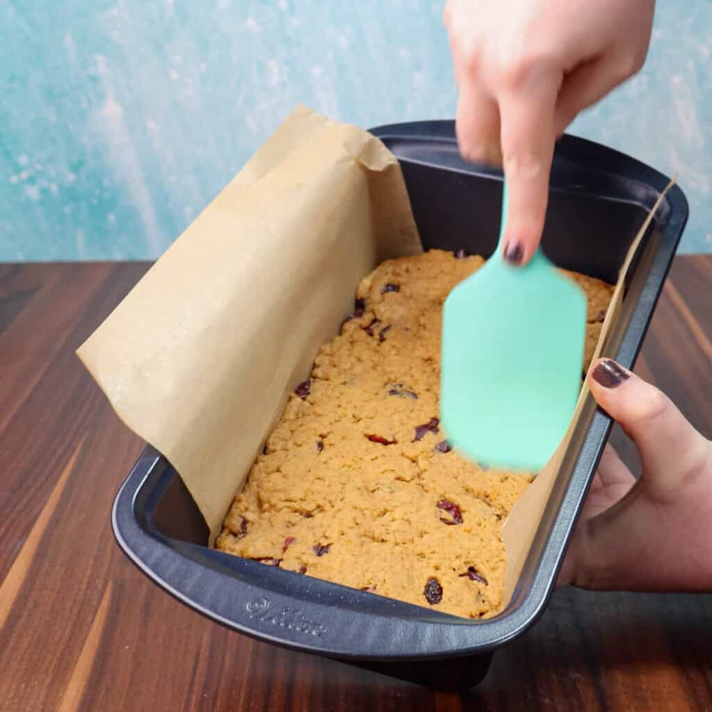 Orange cranberry loaf dough in a loaf pan.