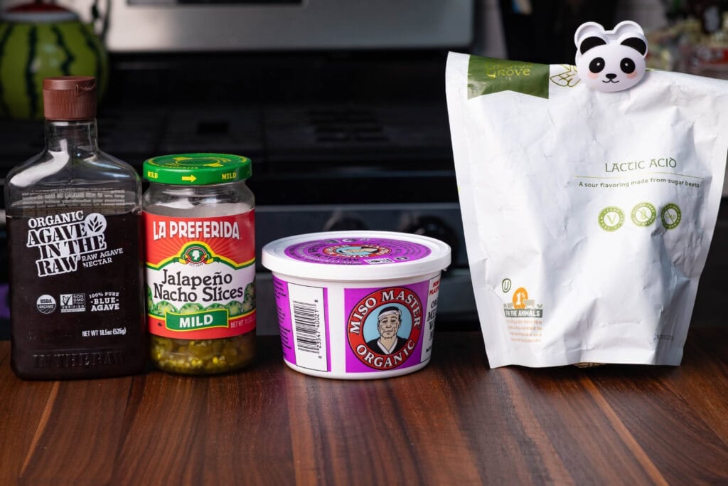 Nacho cheese ingredients - lactic acid, miso paste, jalapeno brine and agave syrup.
