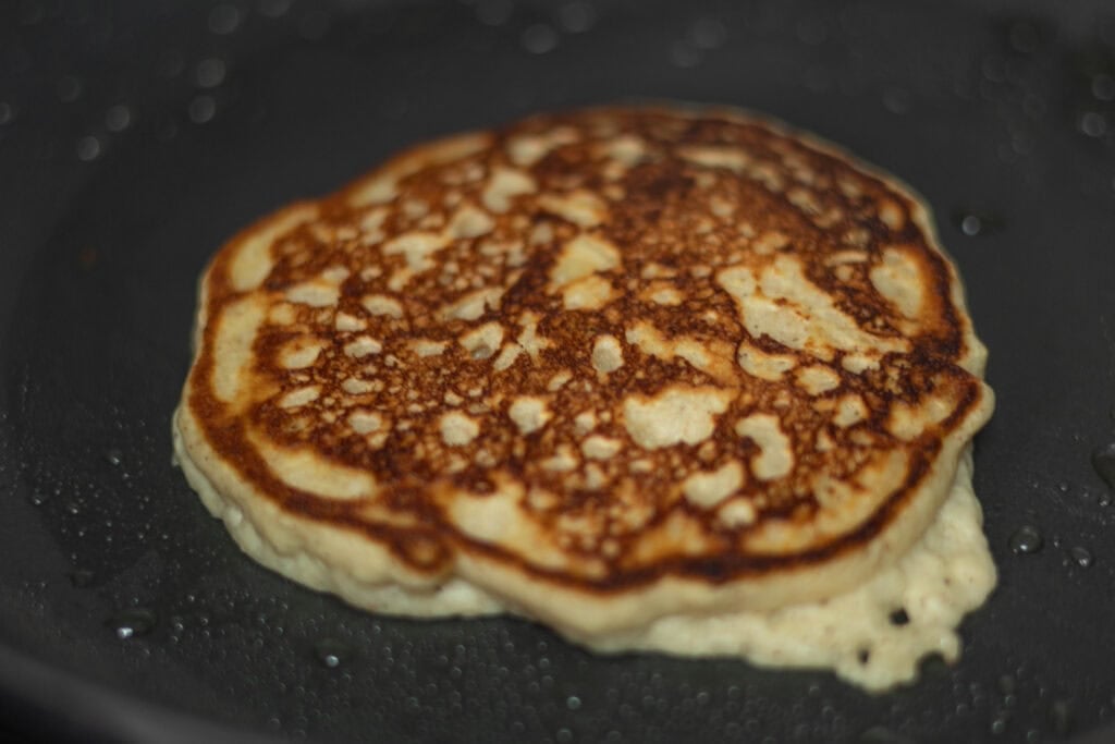 High protein banana pancake in a pan.