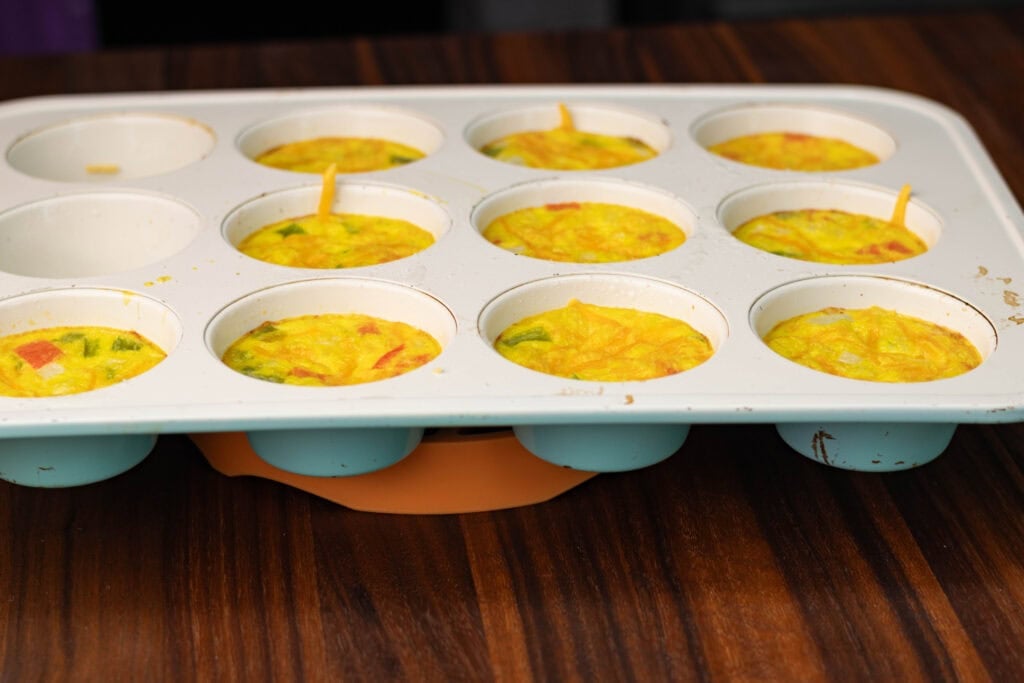 Vegan egg bites, cooked, in a muffin tray.