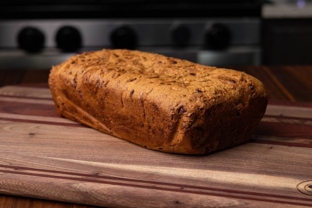 High Protein vegan zucchini bread on a wooden cutting board.