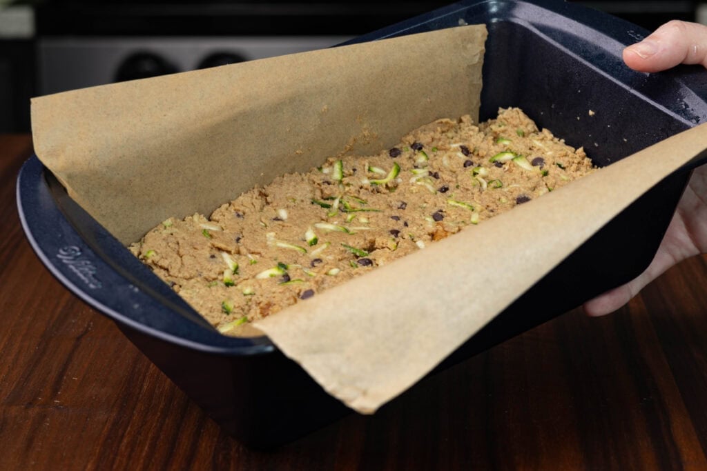 Zucchini bread mixture in a loaf pan, uncooked.