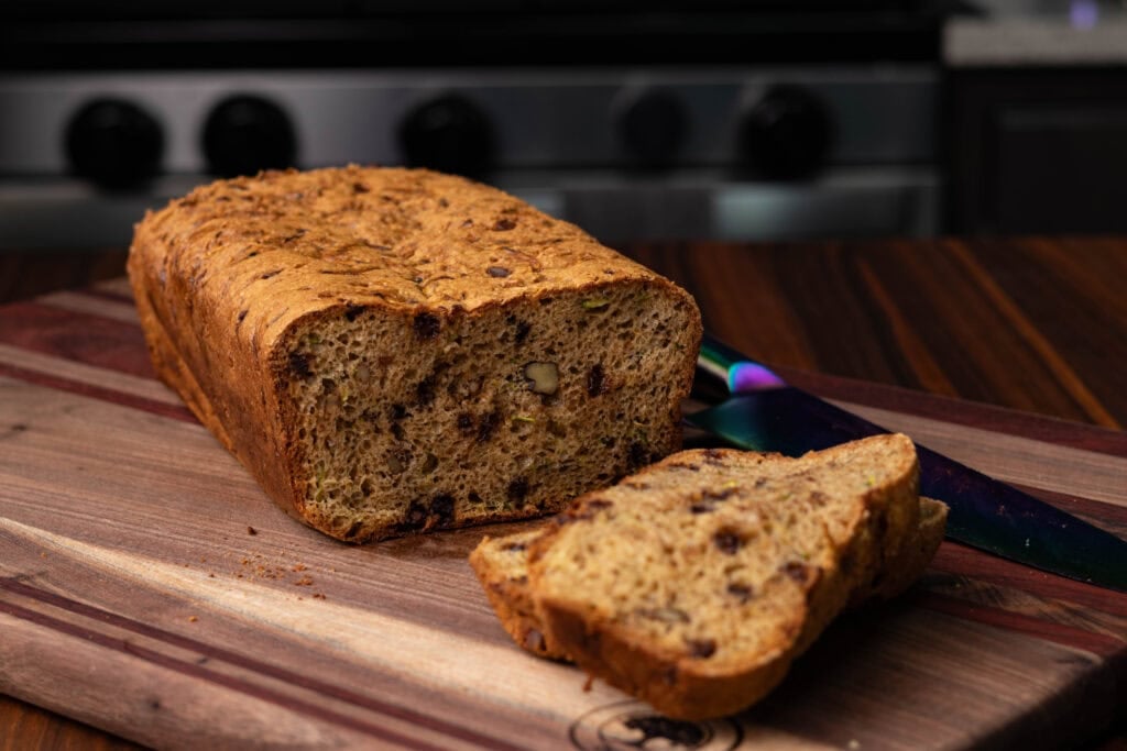 High Protein vegan zucchini bread on a wooden cutting board.